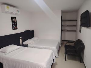 Voodi või voodid majutusasutuse Hotel Palmari toas