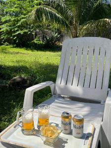 a table with two glasses of beer on a chair at Perfect Place Cozumel - DIANA in Cozumel