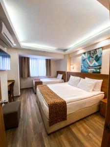 Postel nebo postele na pokoji v ubytování BGuest Hotel & Residence