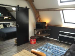 a bedroom with a bed and a black closet at De Weegbrug in IJzendijke