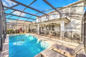 an indoor swimming pool with a glass roof at Getaway Cove Villa in Orlando