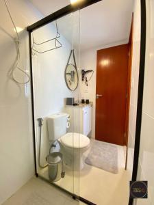 a bathroom with a toilet and a glass wall at Perfect Home in Guarulhos +9 photos