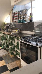 a kitchen with a stove and a counter top at Suites Quebra Mar in Rio de Janeiro