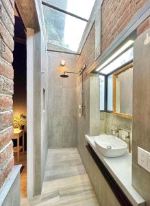 a bathroom with a sink and a large window at Namaste Suite unique urban oasis at The Oliver Cabo in Cabo San Lucas