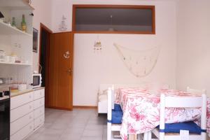 a kitchen with a table with a pink and white table cloth at La Torre guest house in Acireale