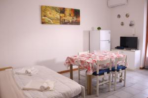 a kitchen with a table and chairs and a refrigerator at La Torre guest house in Acireale +12 photos