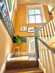 a staircase with a window and a plant in a room at The Red Cow - Guest House in Richmond upon Thames