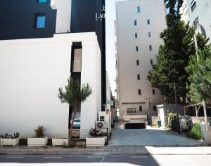 a street in a city with a building at La Onda Hotel Durres in Durrës