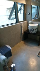 a bathroom with a sink and a large window at Athina Art Apartments in Athens