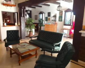 a living room with two chairs and a coffee table at Hotel Medina y Mar BnB in Mar del Plata +70 photos