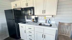 A kitchen or kitchenette at 1 Block to Beach -Brand New Modern Tiny Home