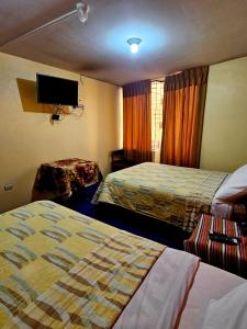 Giường trong phòng chung tại Julio Cesar HOTELES +5 ảnh