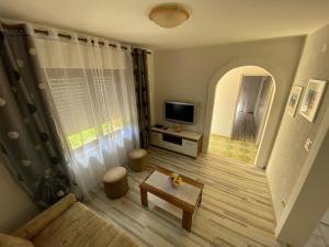 a living room with a couch and a tv at Apartment Vito in Povile