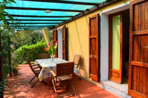 a patio with a table and chairs on a house at Lacona in Lacona