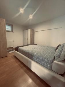 a bedroom with a large bed and a cabinet at Apartman 007 in Jajce