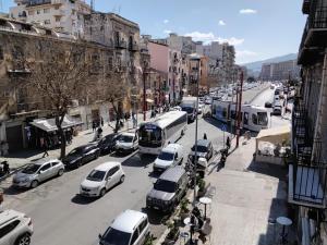 a busy city street filled with cars and buses at B&B Central Station in Palermo