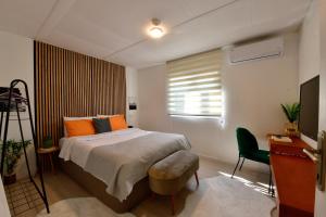 a bedroom with a bed and a desk and a television at İZNİK Lake Olive villa in İznik +32 photos