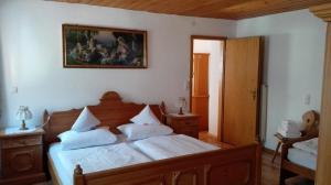 a bedroom with a bed and a painting on the wall at Berghof Moar in Unterwössen