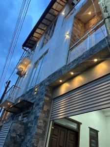 a building with a balcony on the side of it at Nomad House in Kandana