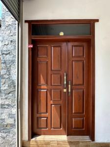 a large wooden door in a building at Nomad House in Kandana +24 photos