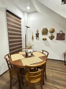 a dining room with a wooden table and chairs at Nomad House in Kandana