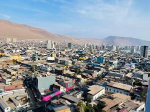 an aerial view of a city with buildings and mountains at Departamento Iquique edificio life in Iquique