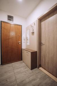 a room with a closet and a wooden door at Darki Apartments 2 - Very Central Stay With Free Parking in Ohrid