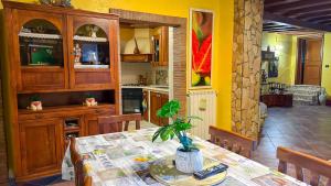 a kitchen with a table with a plant on it at La Dimora del Cavaliere - Stupenda Dimora a 5 Min Dal Lago di Martignano in Anguillara Sabazia