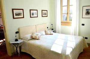 a bedroom with a white bed with two pillows at Residenza Ca' laRipa in Solto Collina