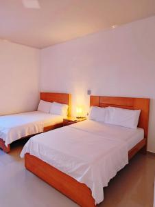 Voodi või voodid majutusasutuse Sagrado Hotel toas