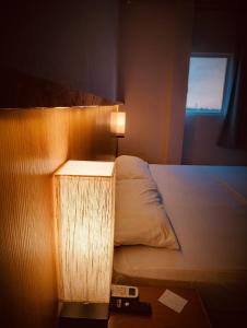 Voodi või voodid majutusasutuse Sagrado Hotel toas