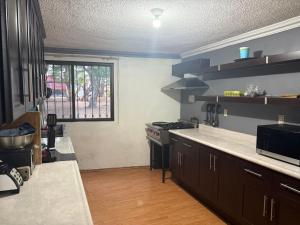 a kitchen with a stove and a window in it at Departamento Independiente in Morelia