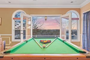 a pool table in a room with a window at Majestic River Castle, A Fairytale Escape on the Coosawatee River in Ellijay