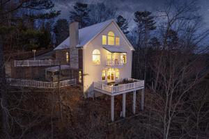 a house with its lights on in the night at Majestic River Castle, A Fairytale Escape on the Coosawatee River in Ellijay