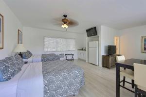 a bedroom with a bed and a table and a television at Sea Beach Plaza in Fort Lauderdale