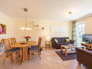 a living room with a table and a couch at holiday apartment with 2 bedrooms in Ostseebad Karlshagen