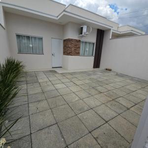 a house with a patio in front of it at Casa Nova 02 in Primavera do Leste