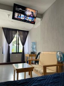 a living room with a couch and a flat screen tv at Lamat 2 in San Pedro La Laguna +24 photos