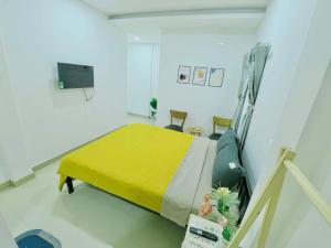 a hospital room with a bed with a yellow blanket at TORI Homestay in Thôn Lại Thê