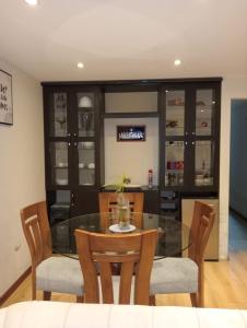 a dining room with a glass table and chairs at Spacious Apartment - Los Olivos in Lima +11 photos