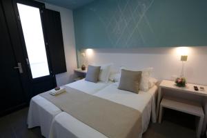 Postel nebo postele na pokoji v ubytování La Pasajera Hostal Boutique