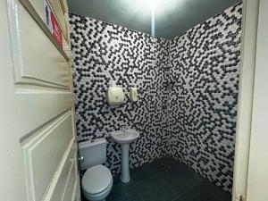 a small bathroom with a toilet and a sink at Casa Espaço Gaibu in Cabo de Santo Agostinho +6 photos