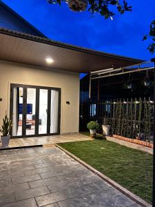 a house with a patio and a fence at Jun Home - Dalat in Da Thanh