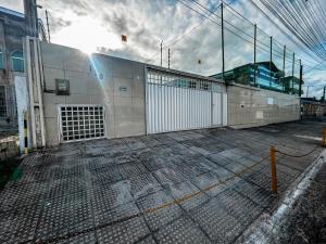 a building with a fence next to a building at Casa Espaço Gaibu in Cabo de Santo Agostinho