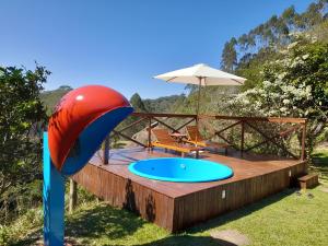 a playground with a slide and an umbrella at Sítio toa toa in Marechal Floriano