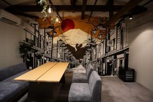a dining room with a table and a mural at 将 -show- in Fujiyoshida