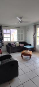 a living room with a couch and a coffee table at Ti kaz mignon 974 in Saint-Louis +21 photos
