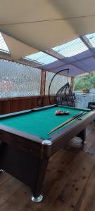 a pool table with two balls on top of it at Ti kaz mignon 974 in Saint-Louis