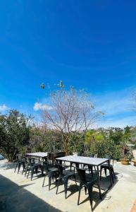 a group of tables and chairs on a patio at Hạ Hoàng Hôn House & Coffee in Da Lat