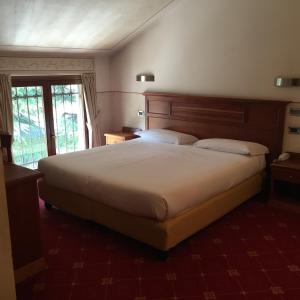 duże łóżko w pokoju hotelowym z oknem w obiekcie La Pina w mieście Rezzato +36 zdjęć